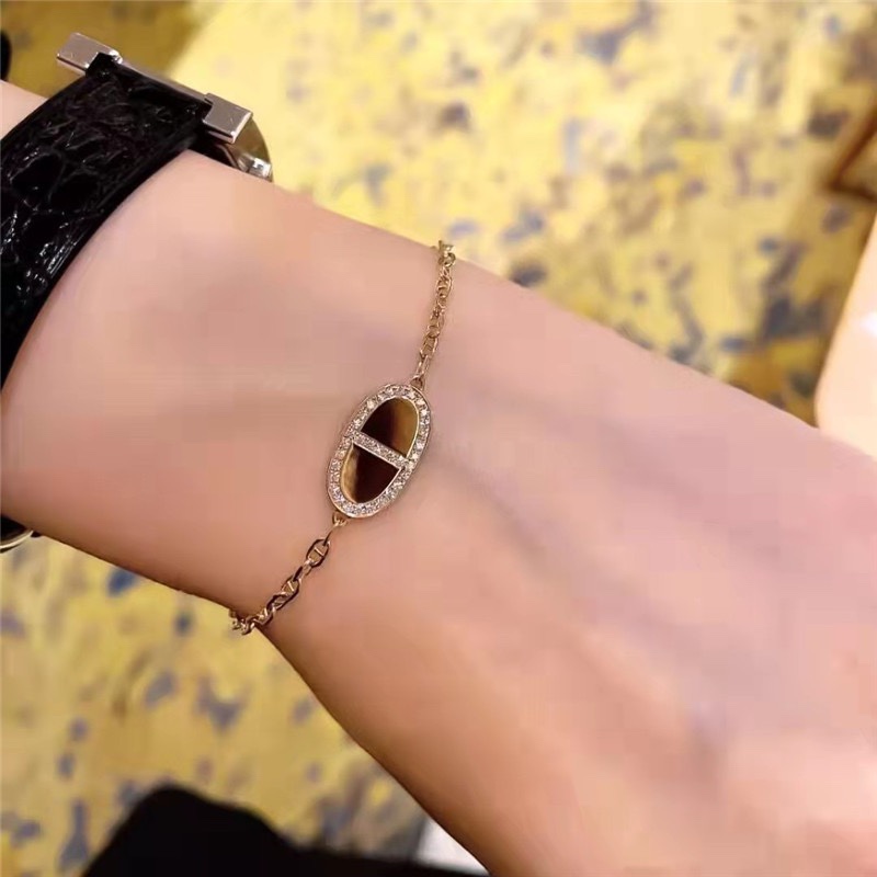 Hermes bracelet with half diamonds on one side and full diamonds on the other